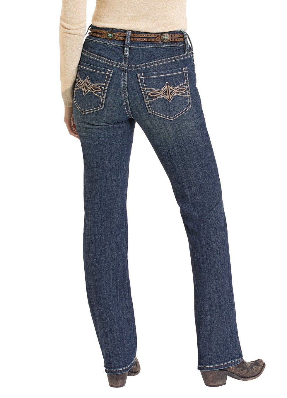 A person is shown from the back wearing Rock & Roll Denim Mid Rise Leather Embroidered Pocket Modest Bootcut Jeans, a tan long-sleeve top, and brown boots.