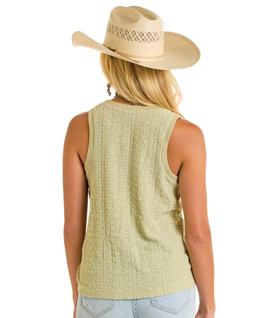 A woman in a wide-brimmed straw hat and Rock & Roll Denim's Raised Knit Tank Top stands with her back to the camera. She pairs the sleeveless, light green knit top with light blue jeans for a casual look against a white background.