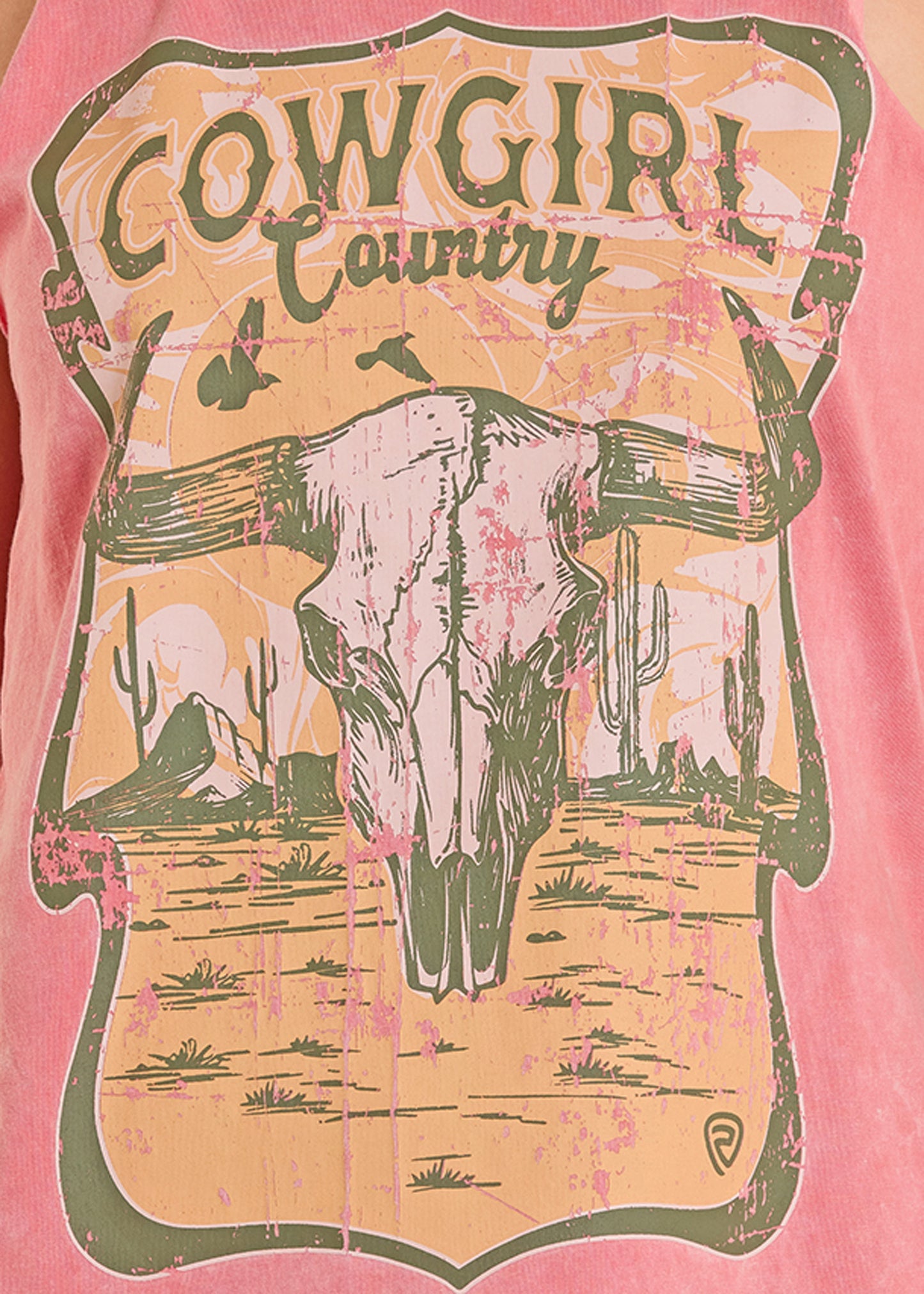 T-shirt with a cowgirl graphic design featuring a skull and cacti on a pink background.
