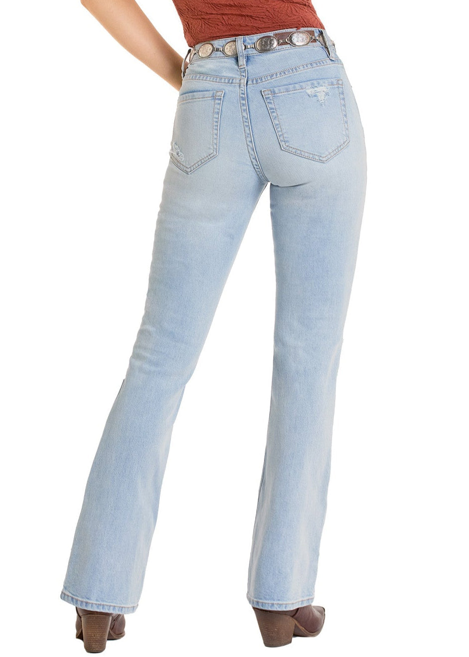 A person wearing Rock & Roll Denim Distressed High Rise Light Wash Bootcut Jeans and brown heels stands with their back to the camera, showing off the jeans’ back pockets and a brown belt with silver accents.