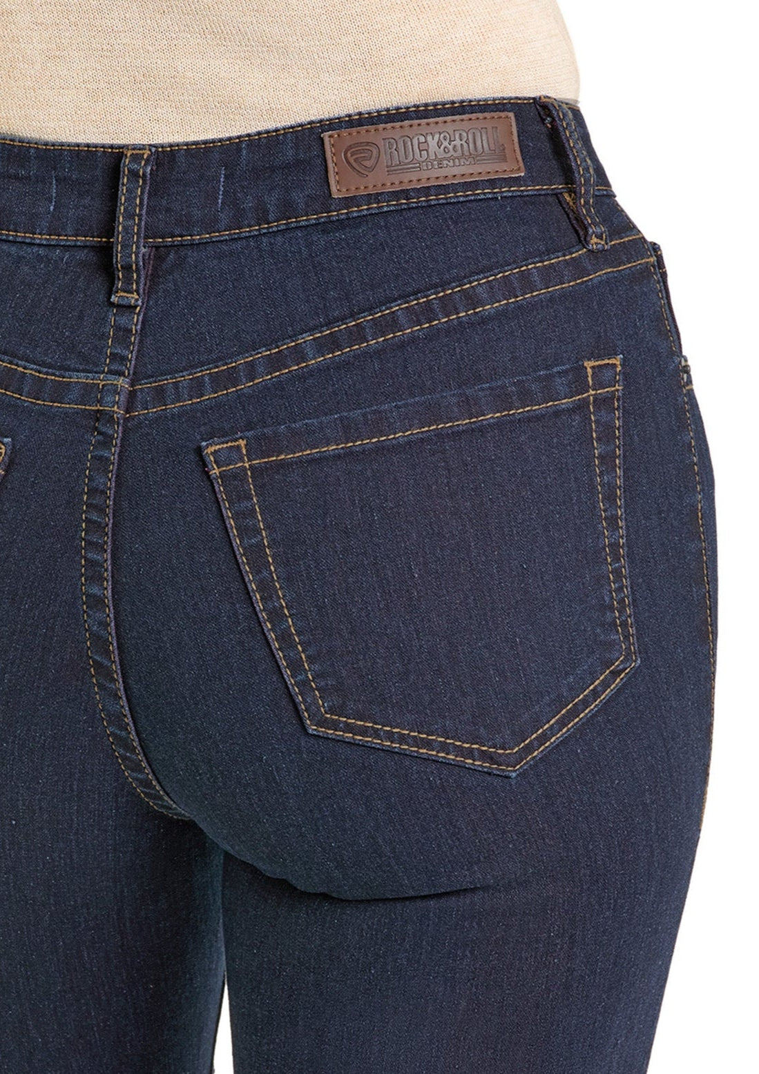 Close-up of the back of a person wearing High Rise Pink Two-Tone Bootcut Jeans featuring tan stitching and a Rock & Roll Denim leather patch on the waistband.