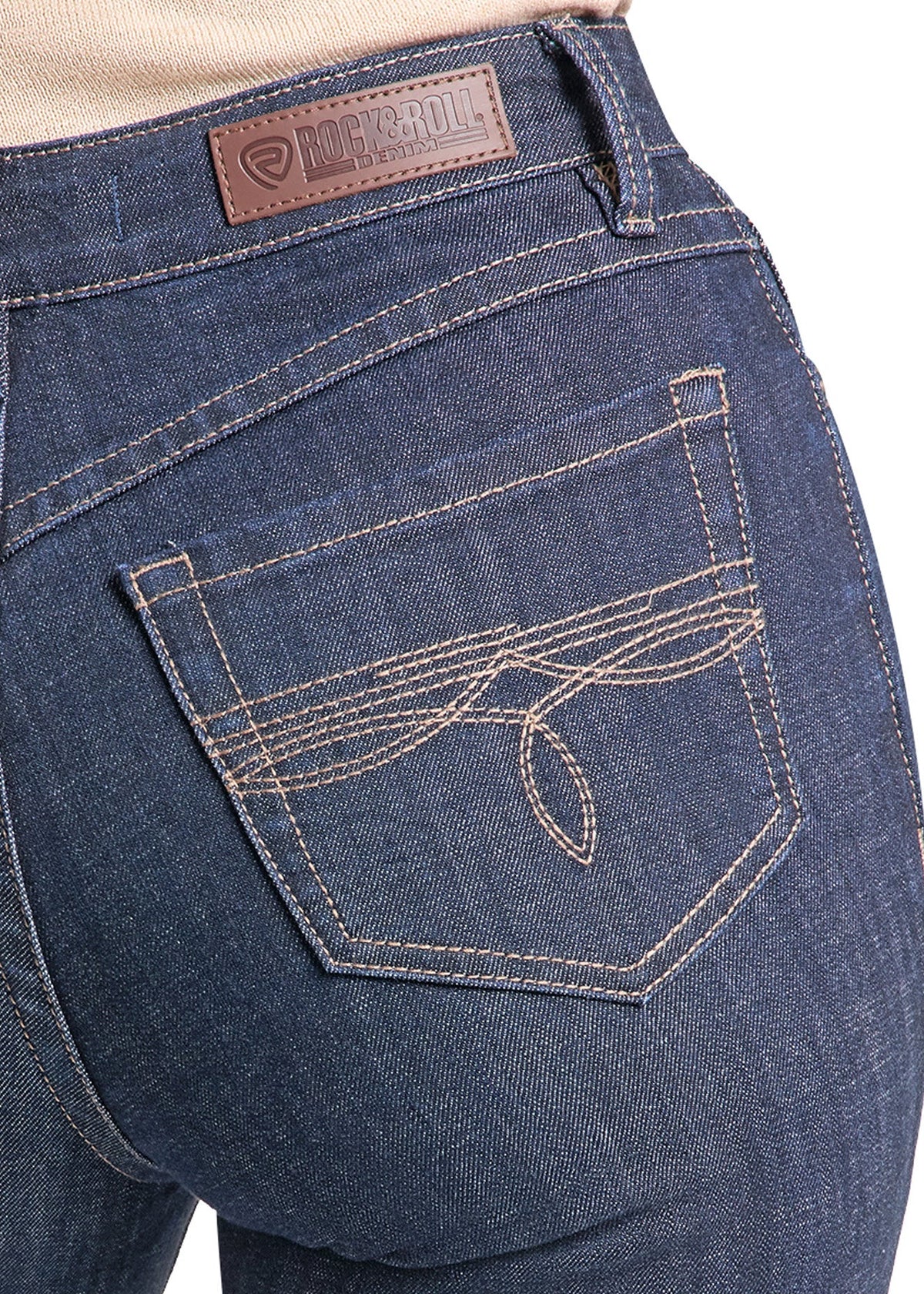 Close-up of the back waistband and pocket area of dark blue denim jeans, showing a brown leather brand patch and contrast stitching.