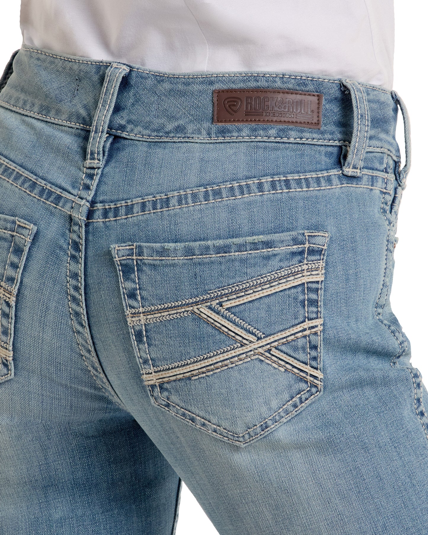 Close-up of the back of a person wearing light blue Mid Rise Cross Stitch Bootcut Riding Jeans with decorative pocket stitching and a brown leather Rock & Roll Denim brand patch on the waistband.