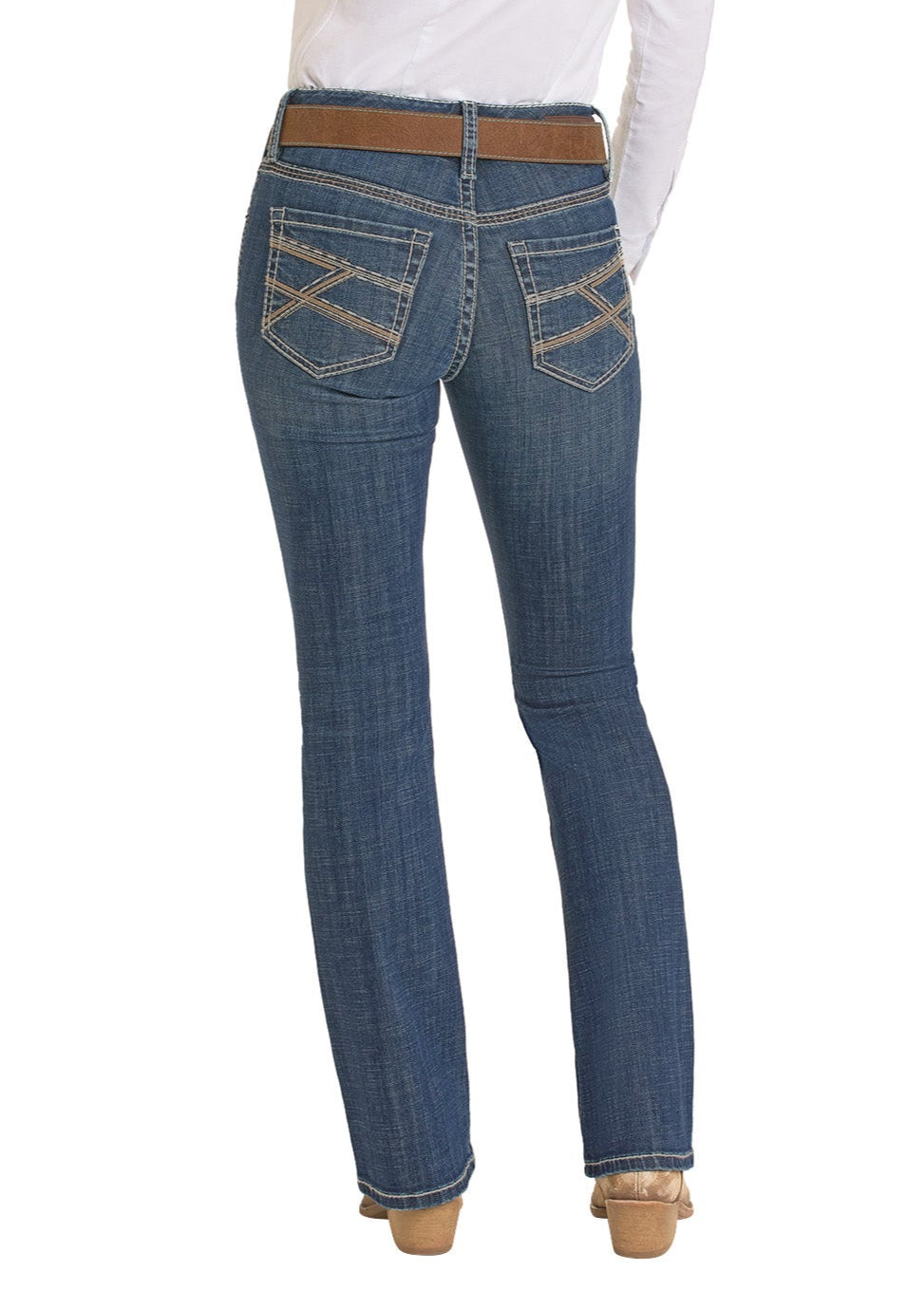A person shown from the back wears Rock & Roll Denim’s Mid Rise Cross Stitch Bootcut Riding Jean in blue, featuring tan stitching, paired with a brown belt, white shirt, and tan heeled shoes.
