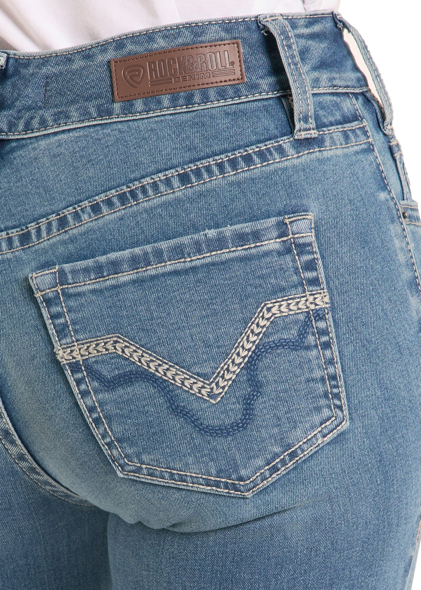 Close-up of blue jeans with a brand label on a white background