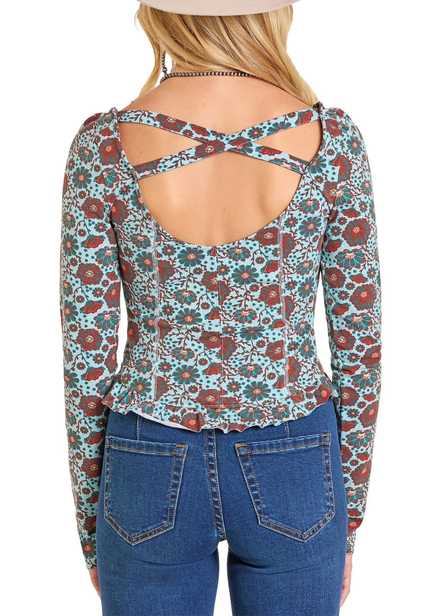 A woman is seen from behind wearing a Rock & Roll Denim Floral Jersey Top with a cross back detail and blue jeans.