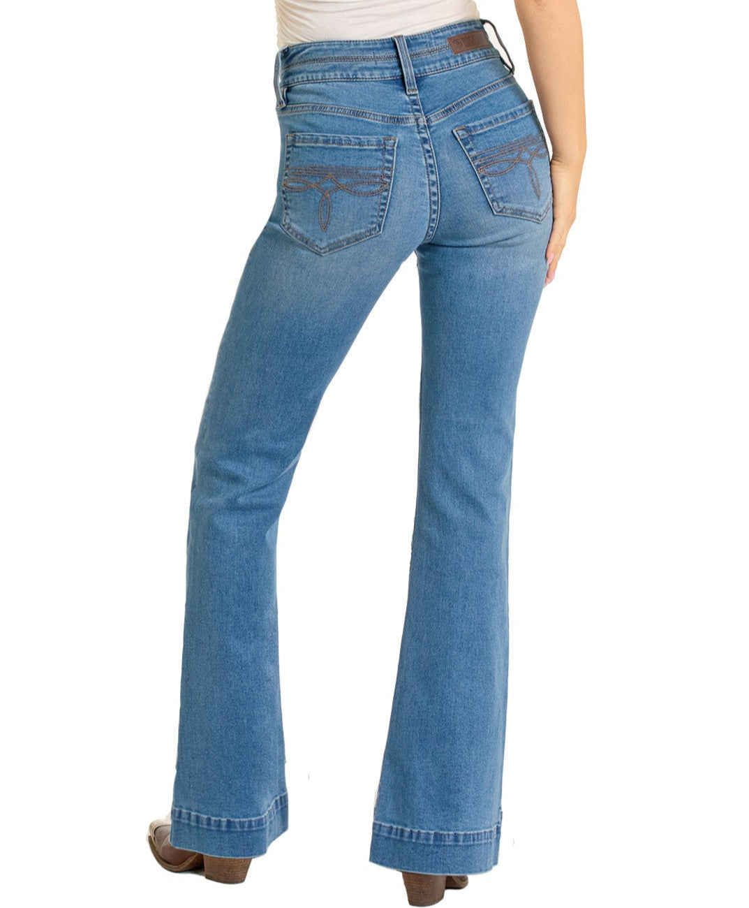 A person wearing Rock & Roll Denim High Rise Double Waistband Trousers in light blue is shown from the back with brown heeled shoes, a white top, and their right hand resting on their hip.