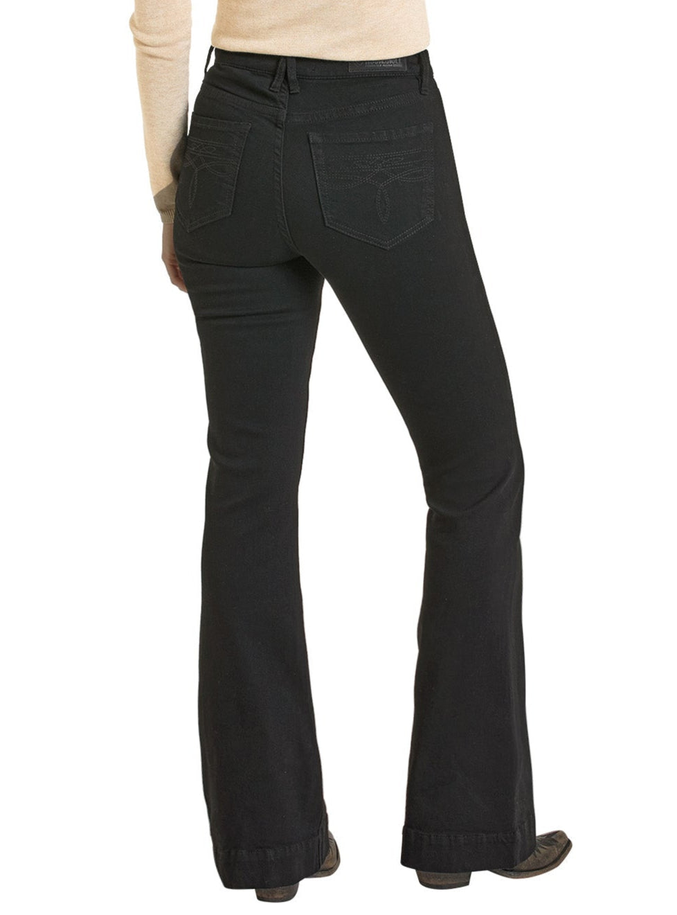 A person stands facing away, wearing a light beige long-sleeve top and Rock & Roll Denim’s High Rise Black Boot Pocket Trouser Jeans, showcasing the jeans’ Western-inspired style and detailed fit.