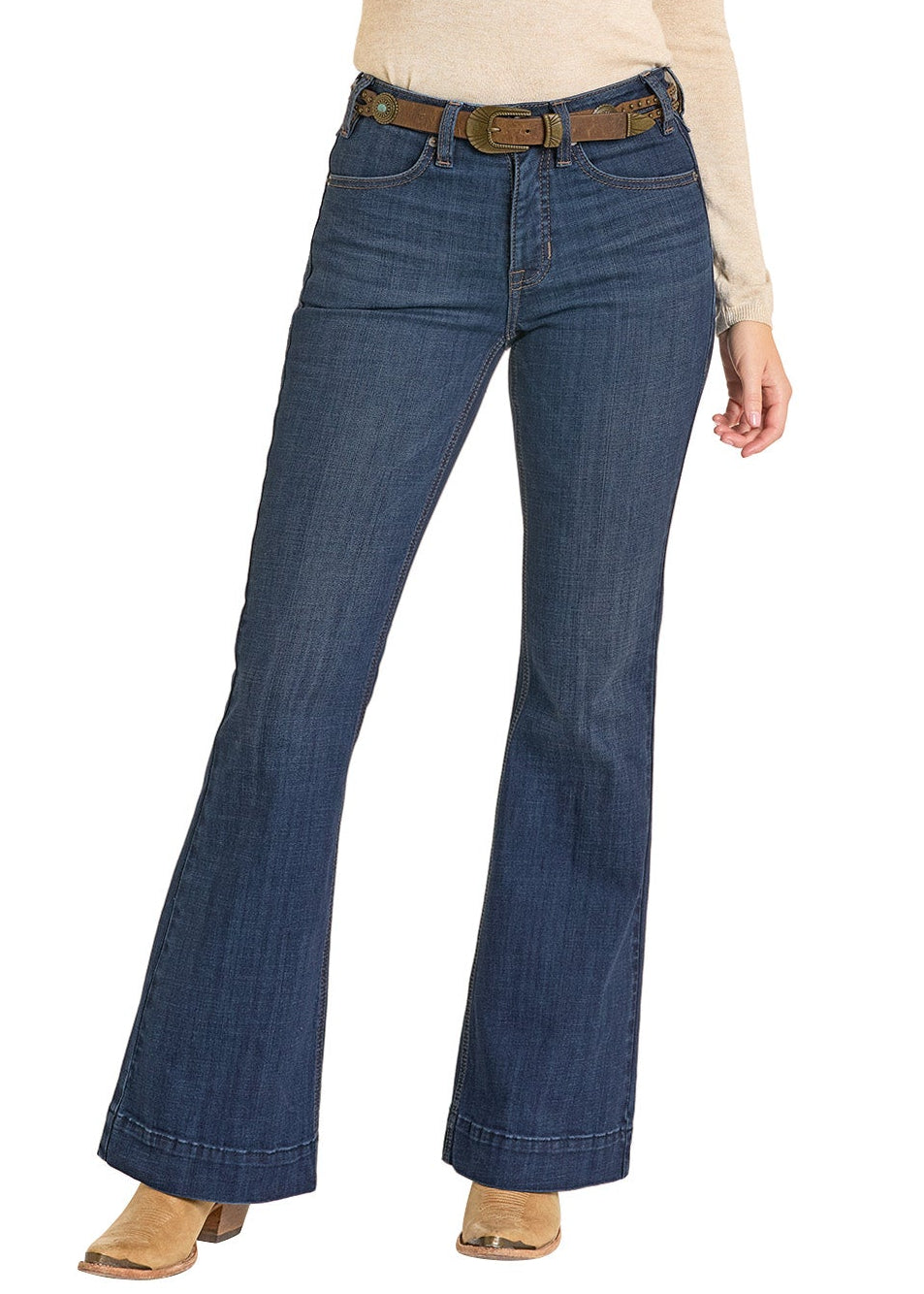 Woman wearing a beige sweater, blue jeans, and a brown hat on a white background