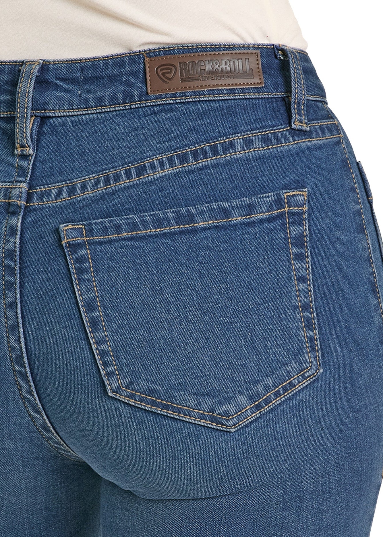 Close-up of blue jeans with a brand label on a white background