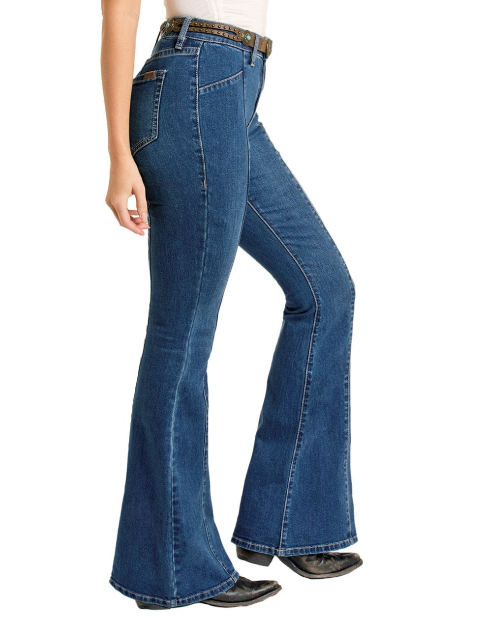 A person wearing Rock & Roll Denim Center Seam Flare Jeans, a brown belt, and black shoes stands sideways with their left arm relaxed at their side. Only the lower torso and legs are visible.