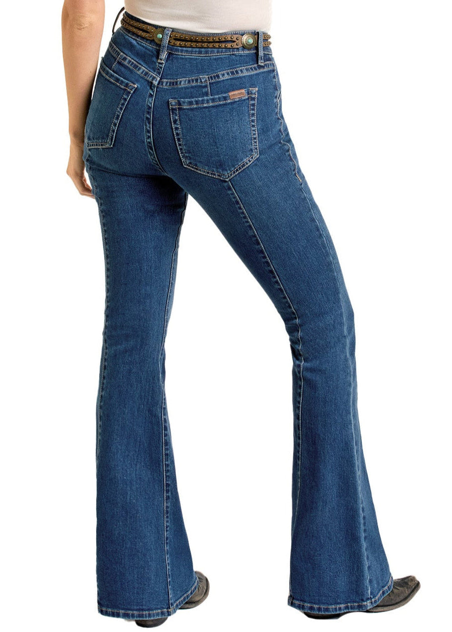 A person is seen from behind wearing Rock & Roll Denim Center Seam Flare Jeans with a white tucked-in shirt and black shoes.