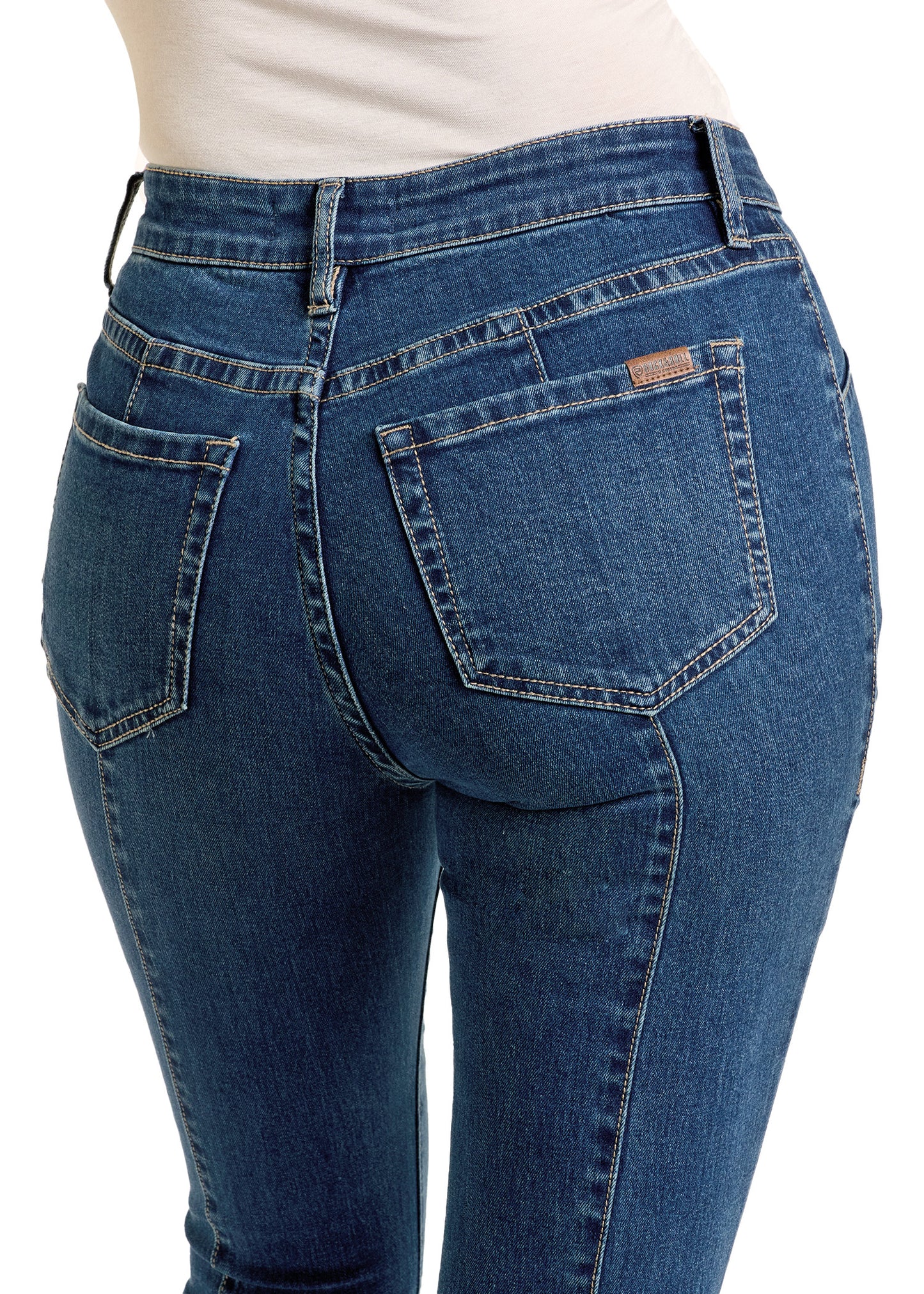 A person wearing Rock & Roll Denim Center Seam Flare Jeans and a white top is shown from the waist down, viewed from the back.