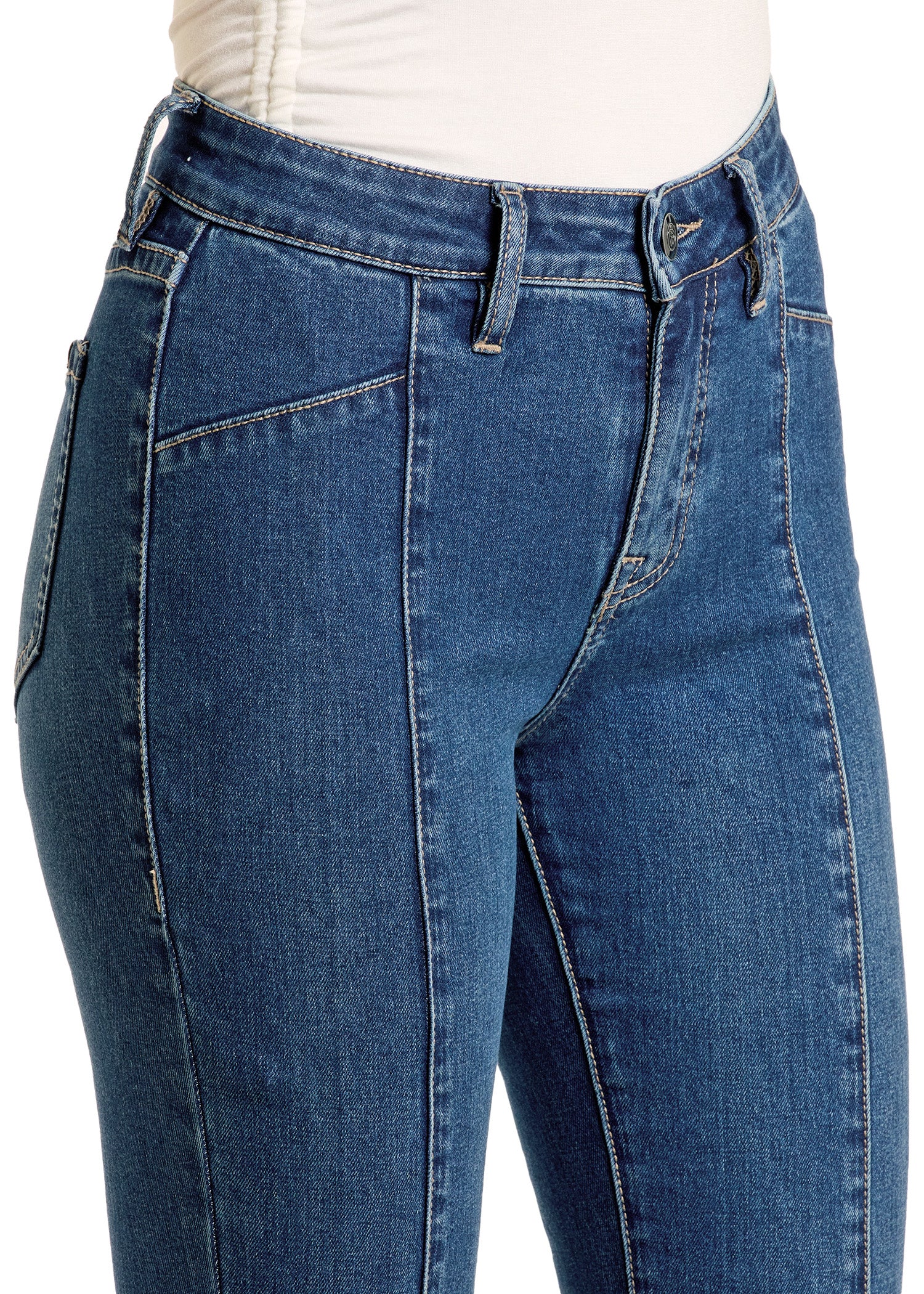 A close-up of someone wearing Rock & Roll Denim’s Center Seam Flare Jeans in blue, featuring high waist, flared legs, contrast stitching, belt loops, front pockets, and a zip fly with button closure paired with a tucked-in white top.