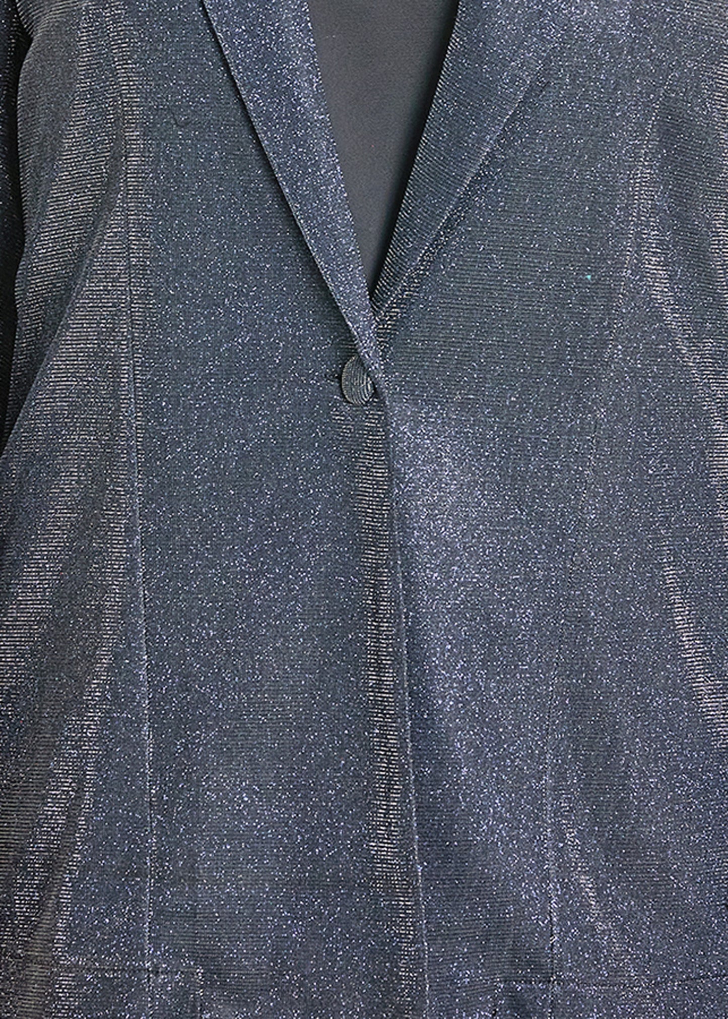 Close-up of a textured gray fabric with a button detail