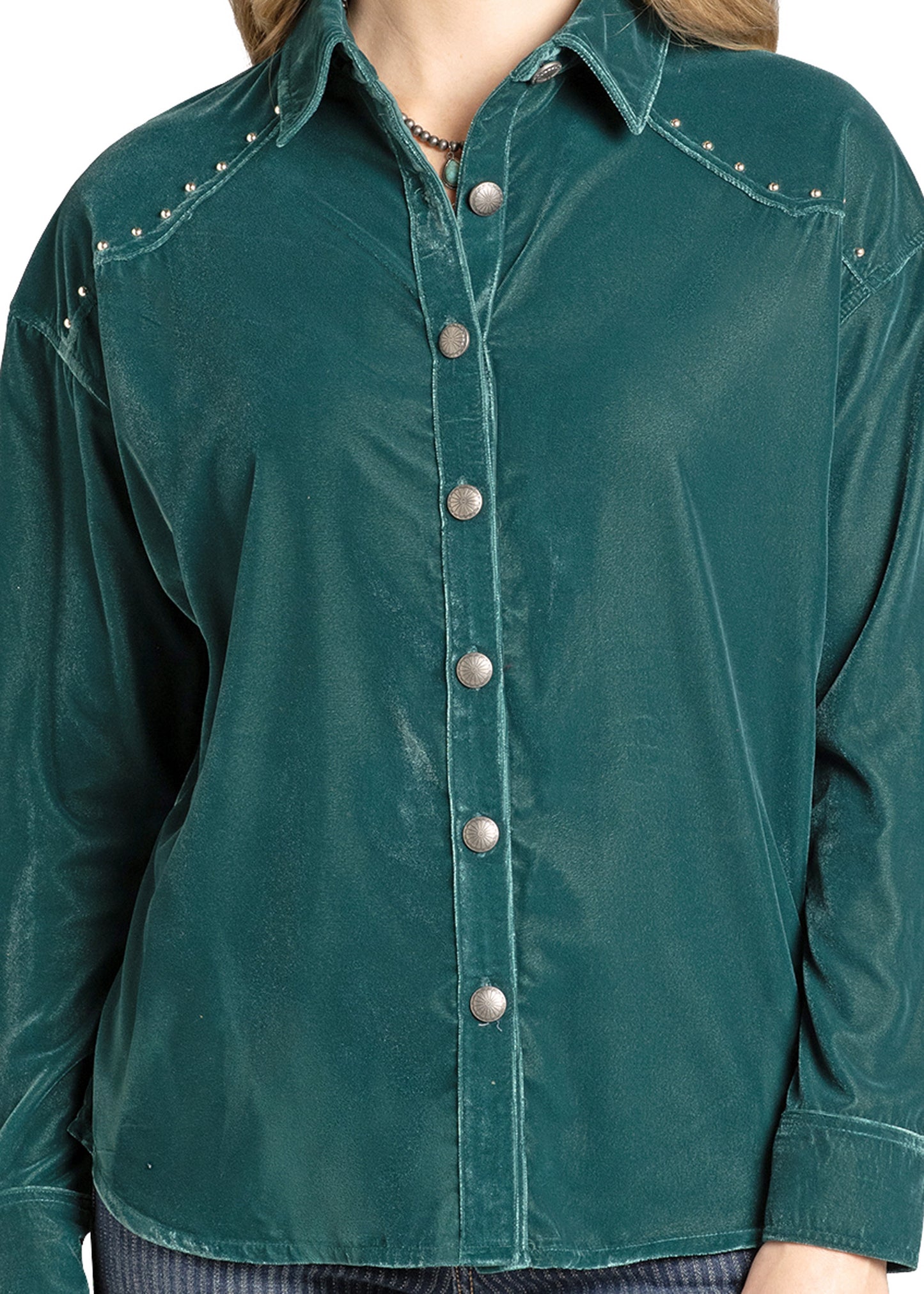 A person wearing the Rock & Roll Denim Velvet Button-Down Blouse in teal, featuring silver buttons and small silver studs on the shoulders. Only the torso is visible.