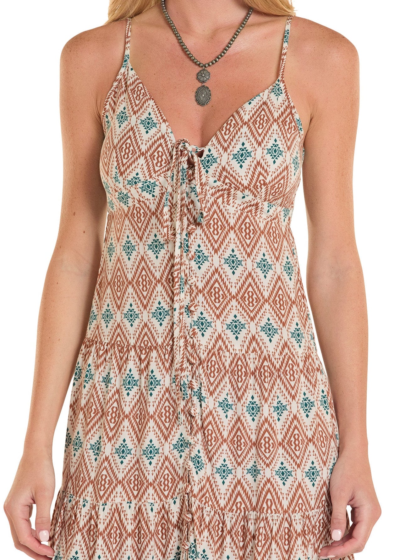 Woman wearing a patterned dress with a necklace on a white background