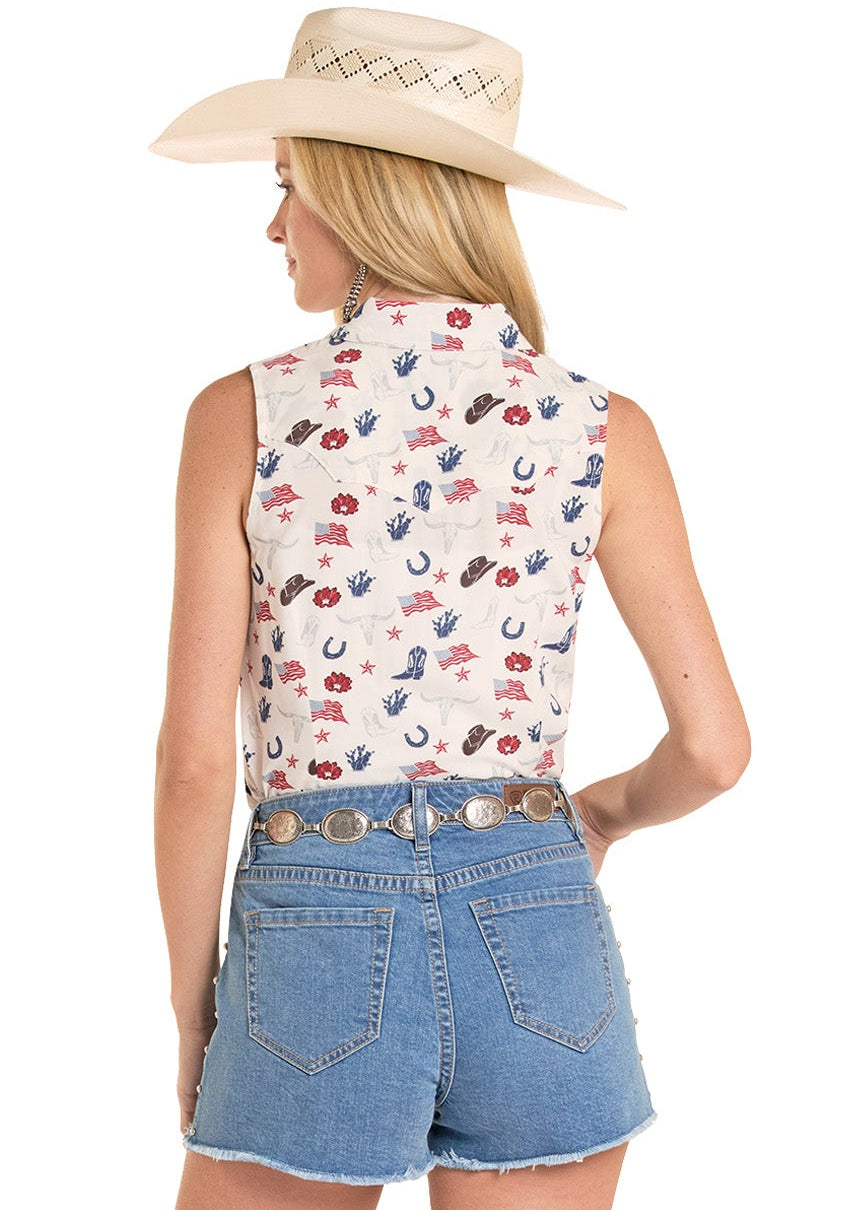 Woman wearing a floral sleeveless top, denim shorts, and cowboy boots on a white background