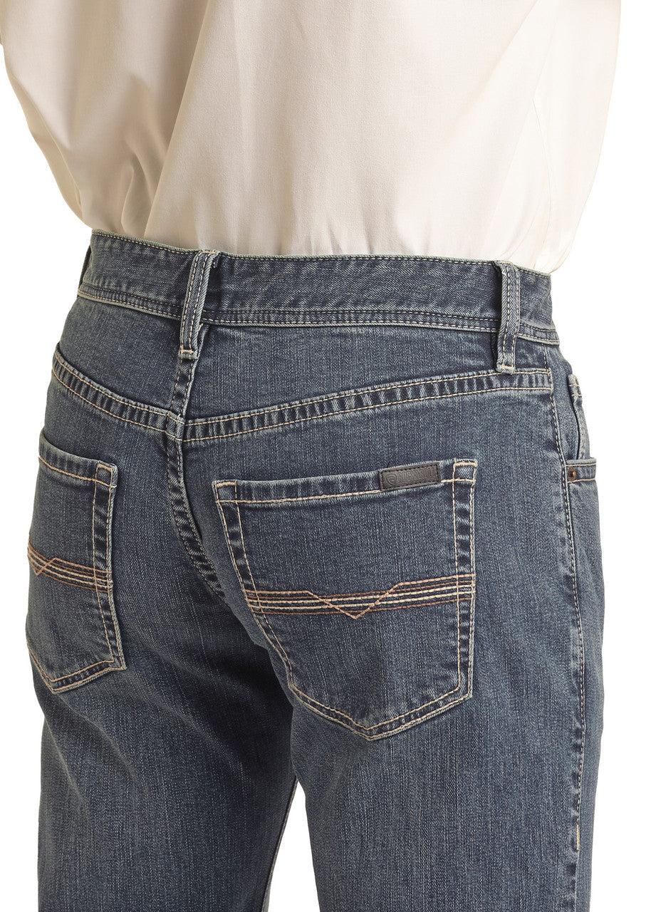 A close-up shows the back of a person wearing Rock & Roll Denim’s Vintage '46 Regular Fit Stackable Bootcut Jeans with a tucked-in white shirt, highlighting the back pockets and waistband.