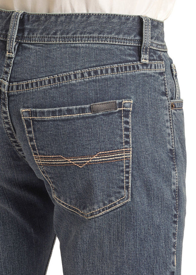 A close-up shows the back of a person wearing Rock & Roll Denim’s Vintage '46 Regular Fit Stackable Bootcut Jeans with a tucked-in white shirt, highlighting the back pockets and waistband.