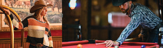 Woman in a striped sweater and hat standing next to a pool table, with a man in a patterned shirt playing pool.