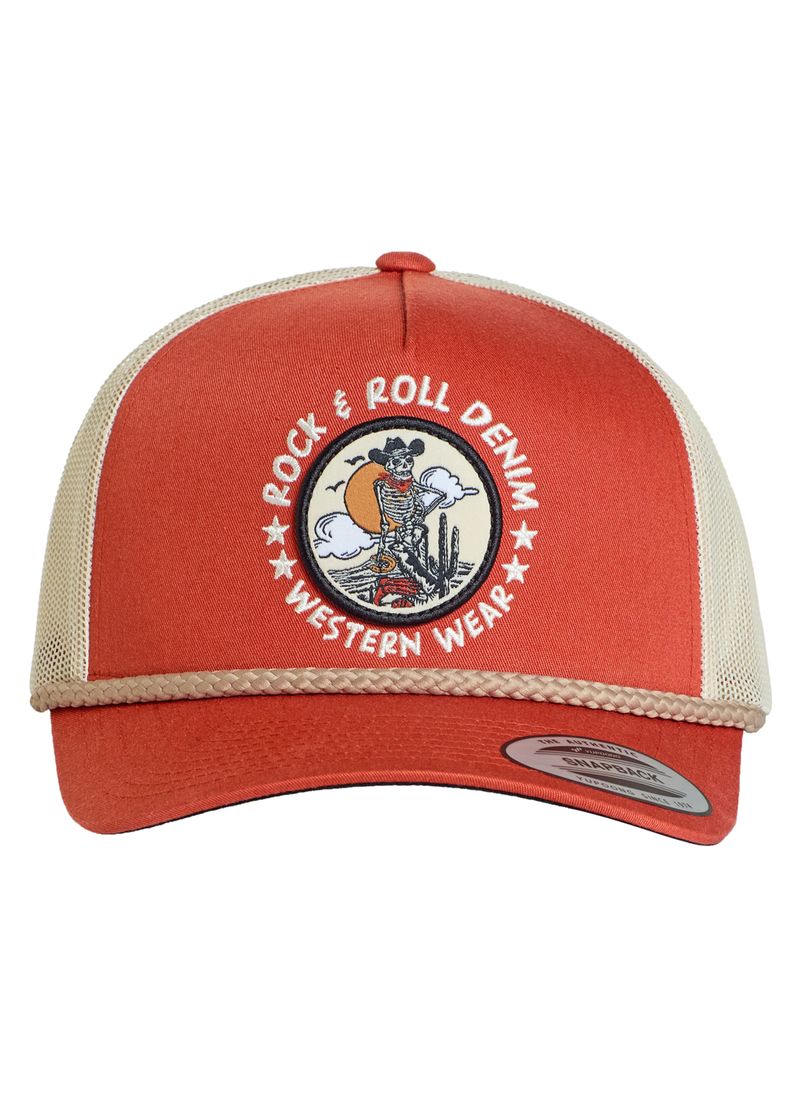 The Rock & Roll Skeleton Cap by Rock & Roll Denim is a red and beige trucker hat with a mesh back and a circular patch featuring a cowboy riding a horse next to cacti.