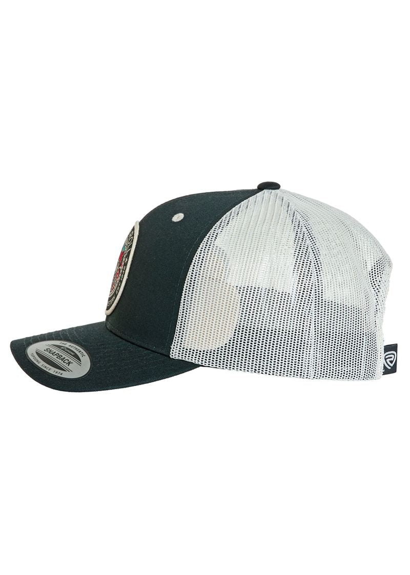 The Rock & Roll Saddle Bronc Cap by Rock & Roll Denim is a black and white adjustable snapback trucker hat with mesh back, curved brim with sticker, and a round front patch, shown in side view.