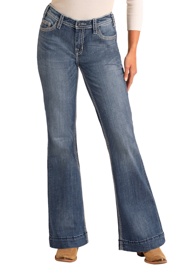 Woman wearing a white long-sleeve top and blue jeans with a straw hat on a white background