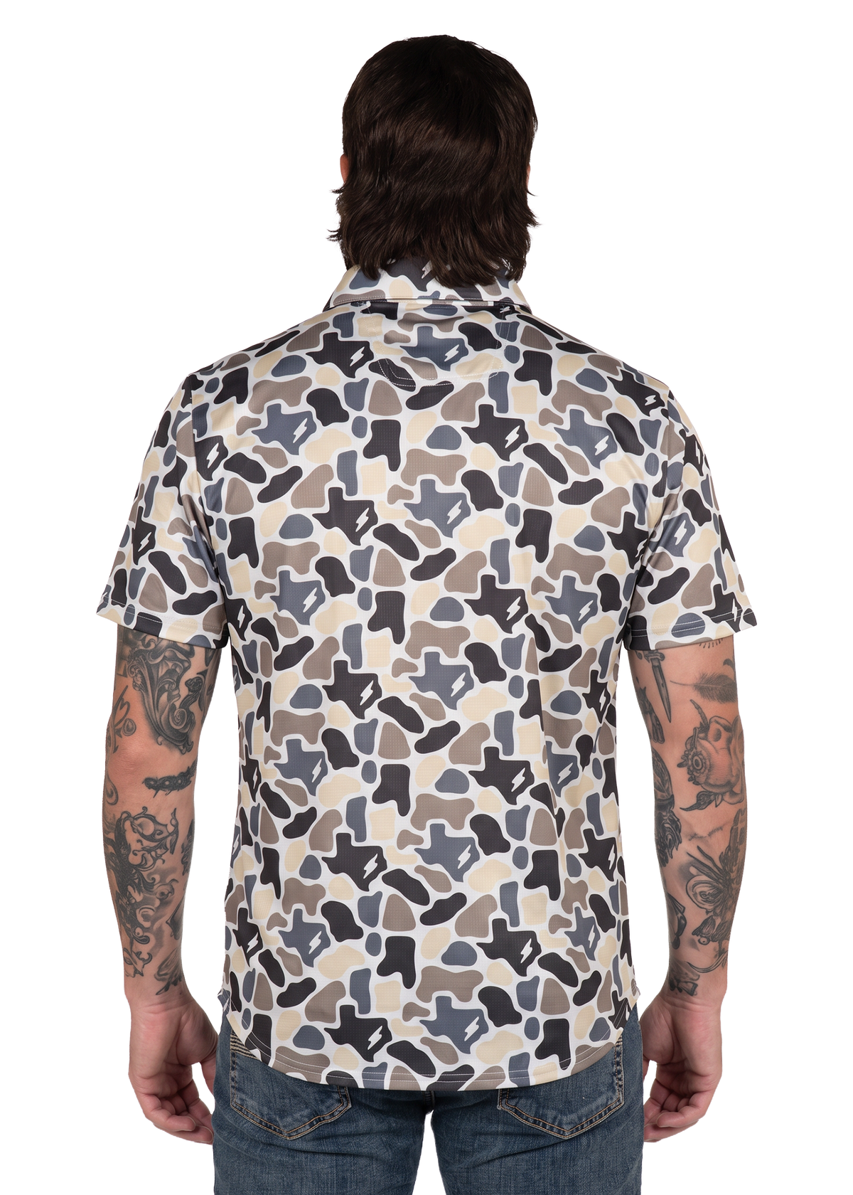 Koe Wetzel viewed from the back wearing a short-sleeve button-up shirt with an abstract camouflage pattern in beige, gray, and black, paired with blue jeans against a white background.
