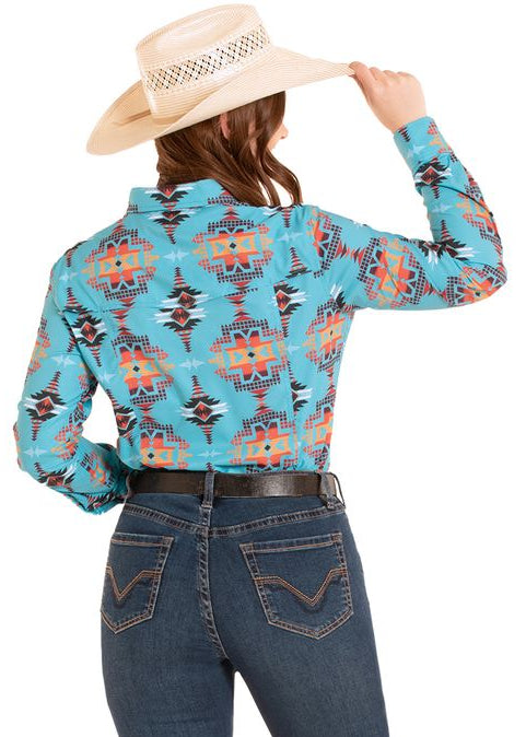 Woman wearing a patterned long-sleeve shirt and jeans with a cowboy hat on a white background