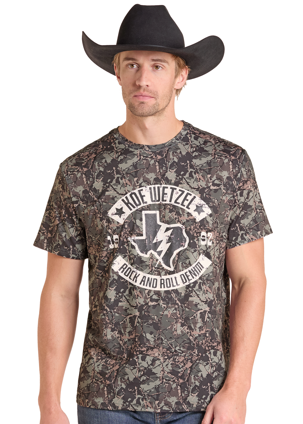 A man wearing a black cowboy hat and a short-sleeve camouflage graphic t-shirt with a white 'Kode Wetzel Rock and Roll Devil' logo on the chest, set against a plain white background.