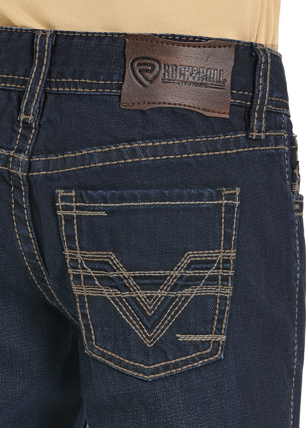 Close-up of dark blue jeans with a brand logo on the pocket and waistband.