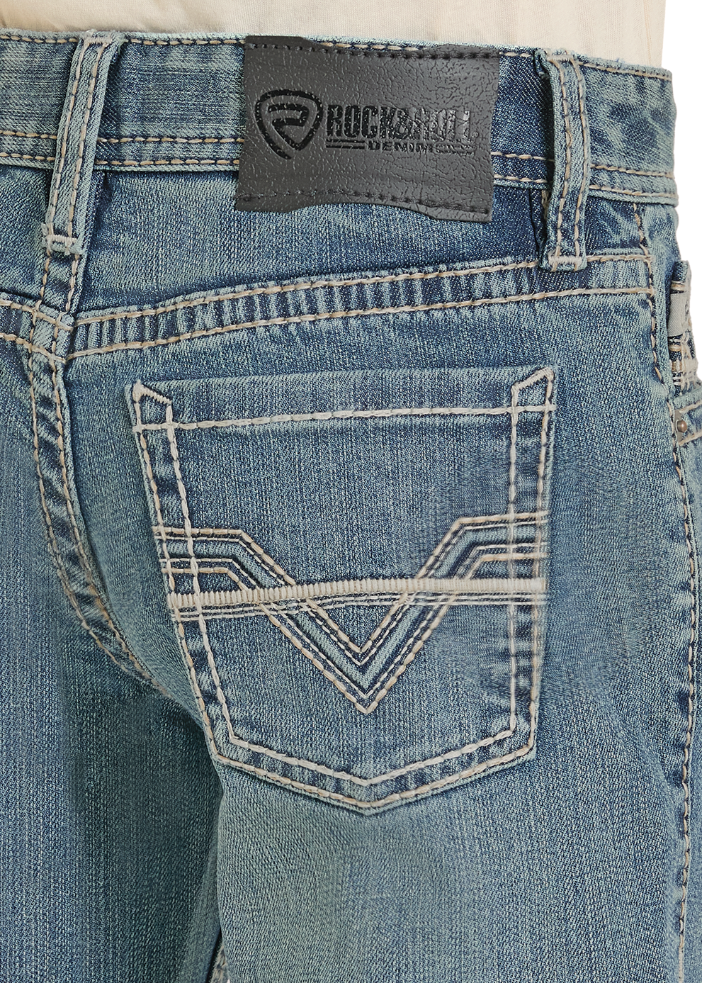 Close-up of blue jeans with a brand label on a white background