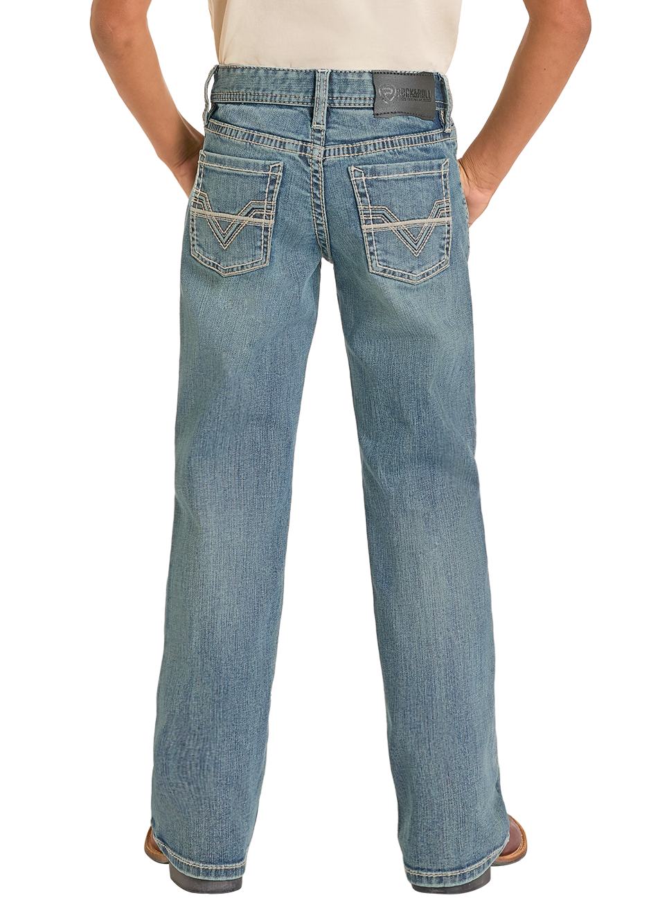 Person wearing a black cowboy hat, beige shirt, and blue jeans on a white background