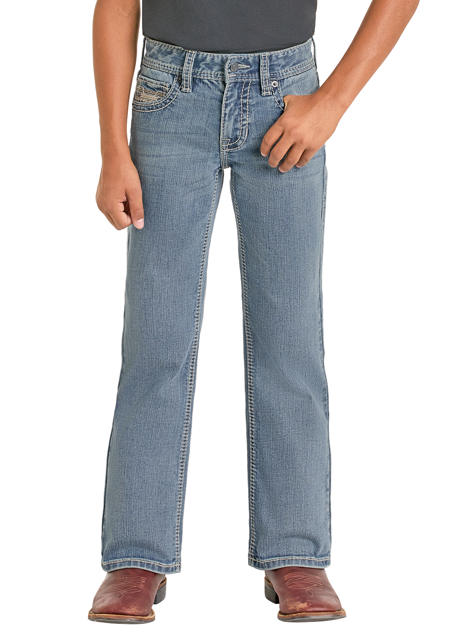 A person wears Rock & Roll Denim Boys' Regular Fit Light Feathered Stitch Bootcut Jeans, a dark belt, and brown cowboy boots, standing with one hand in their pocket against a plain white background.