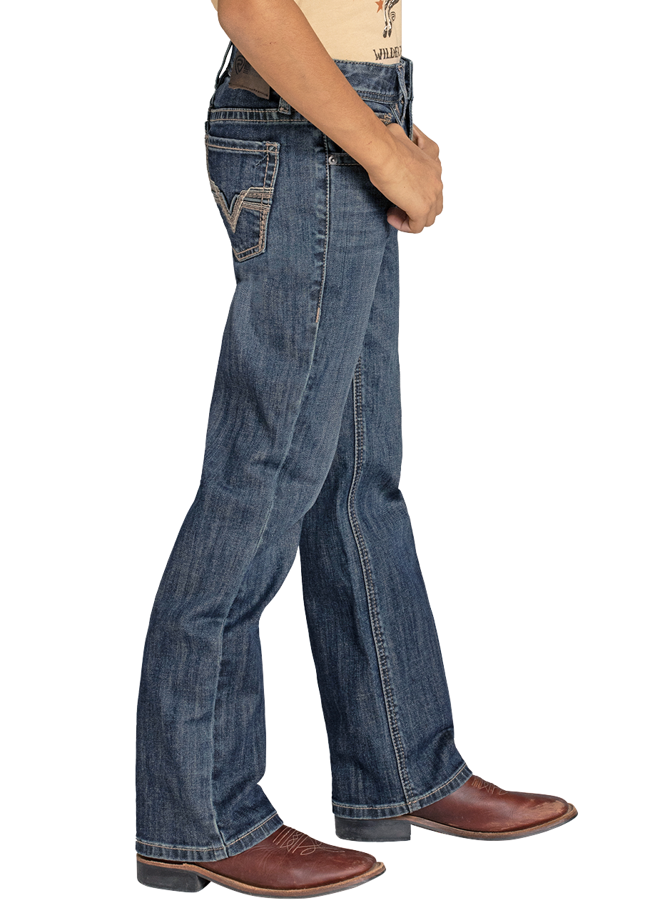 A person in Rock & Roll Denim Boys' Regular Fit Feather Stitch V Bootcut Jeans stands sideways, hands in front, wearing blue jeans with white stitching and brown leather cowboy boots.