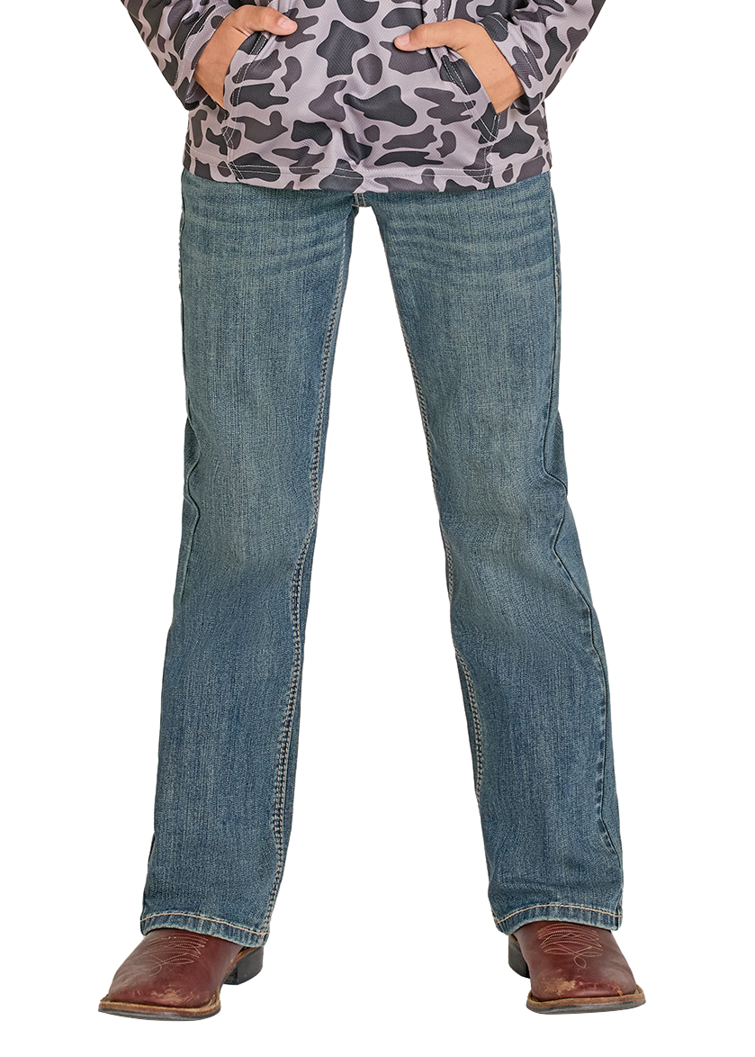 Child wearing a leopard print shirt, jeans, and a cowboy hat on a white background