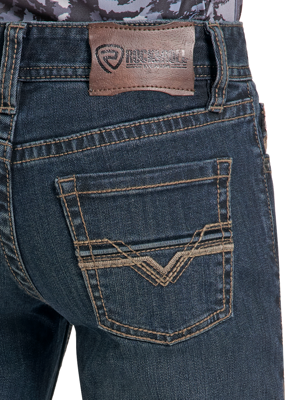 Close-up of the back waistband and rear pocket of dark blue denim jeans, showing a brown leather patch with the Reel It brand logo and contrast stitching.