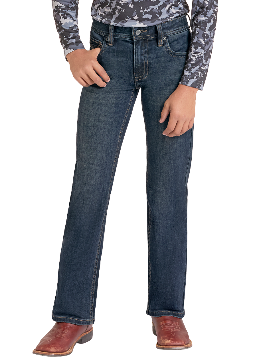 A young boy modeling a western outfit consisting of a long-sleeve camouflage-patterned shirt, dark blue jeans, a black cowboy hat, and brown boots, set against a plain white background.