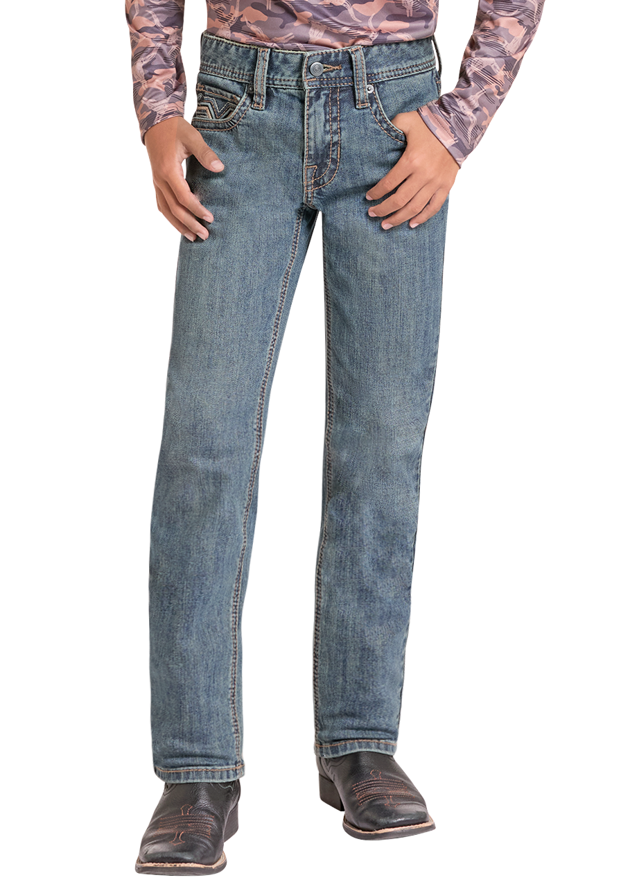 A young boy modeling a long-sleeve western-style shirt with a pink, purple, and brown camouflage pattern, paired with blue jeans, a black cowboy hat, and brown boots, on a solid white background.
