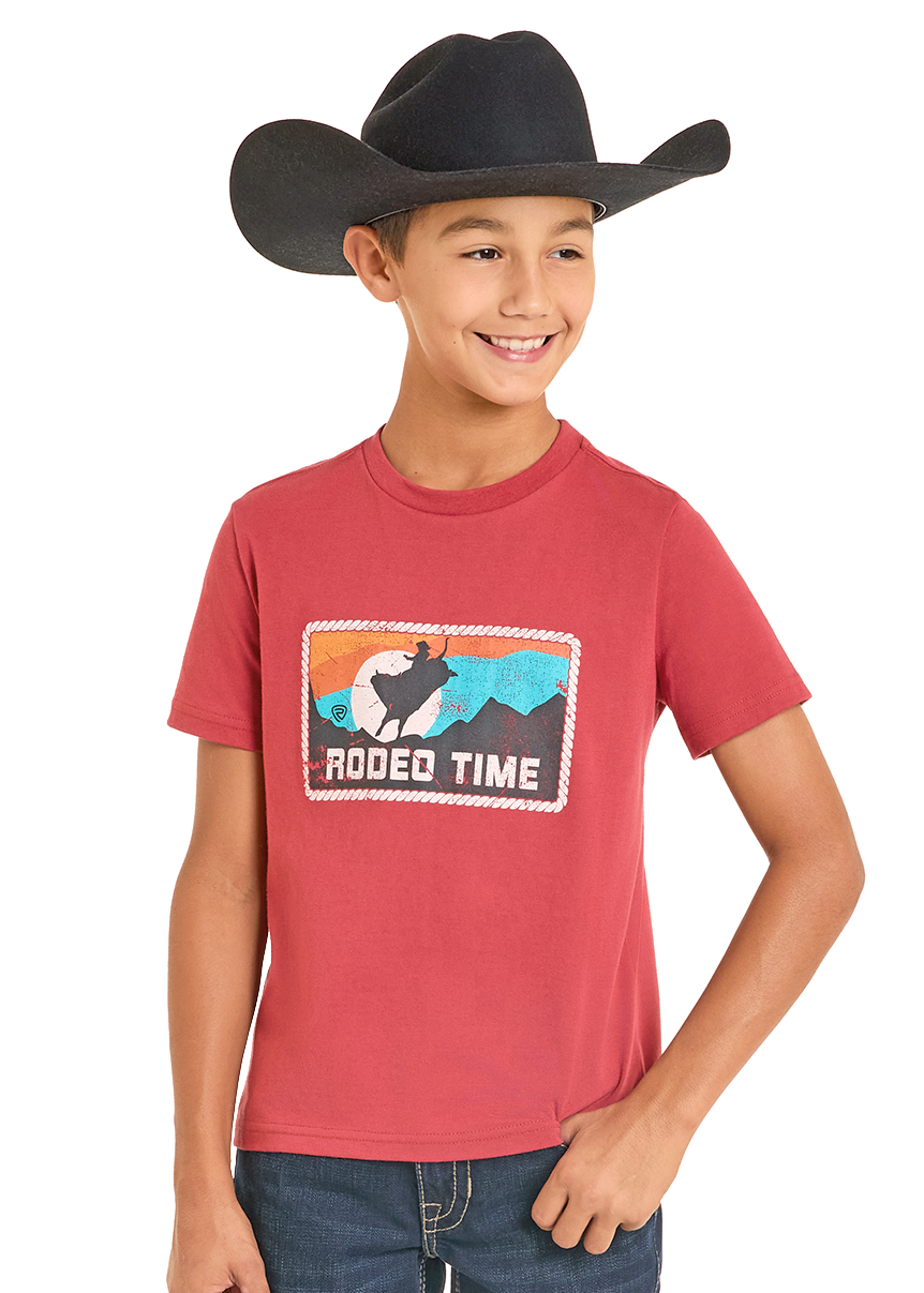 Child wearing a red t-shirt with a graphic design and blue jeans on a white background