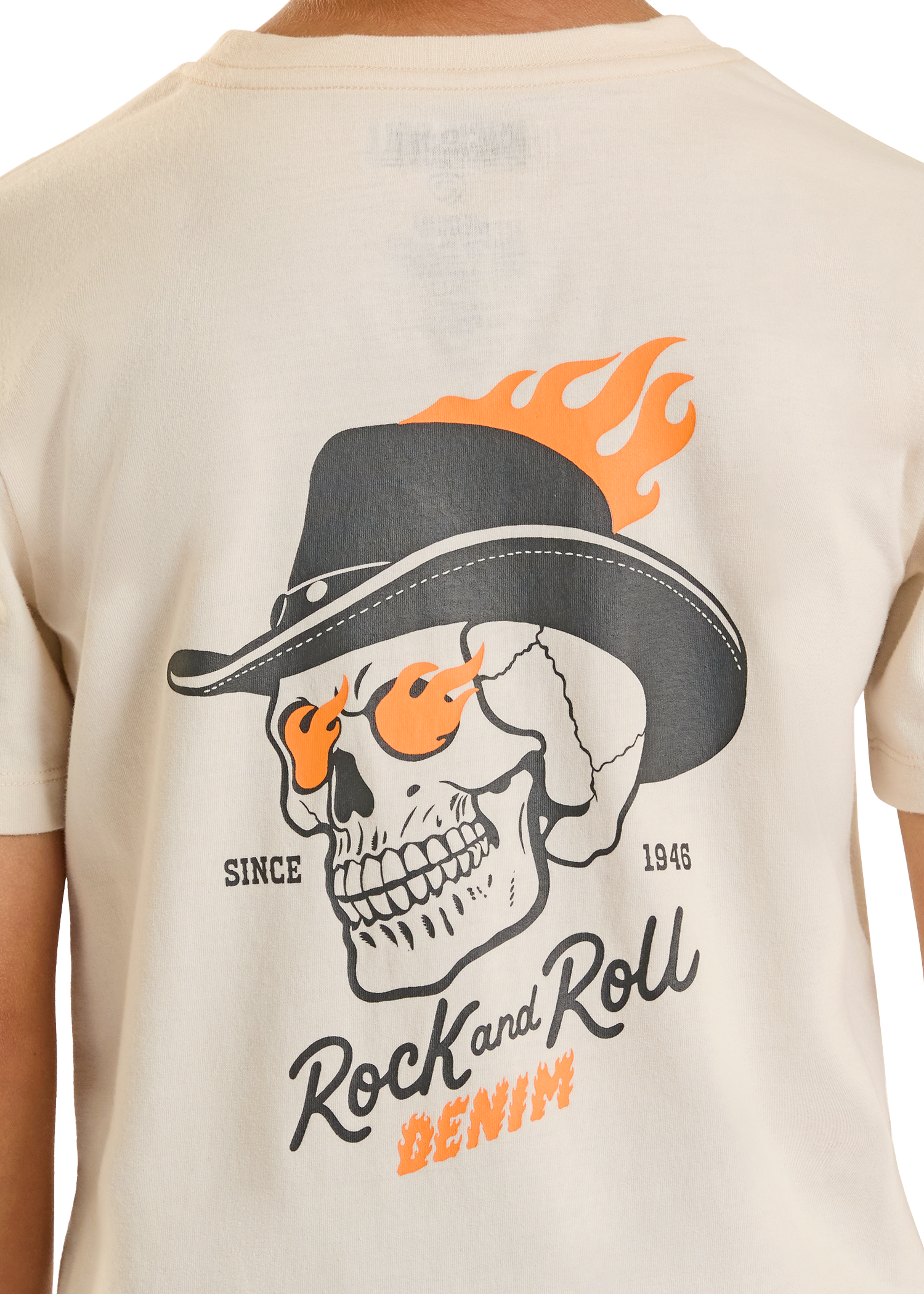 Beige t-shirt with a skull wearing a hat and flames graphic on the back.