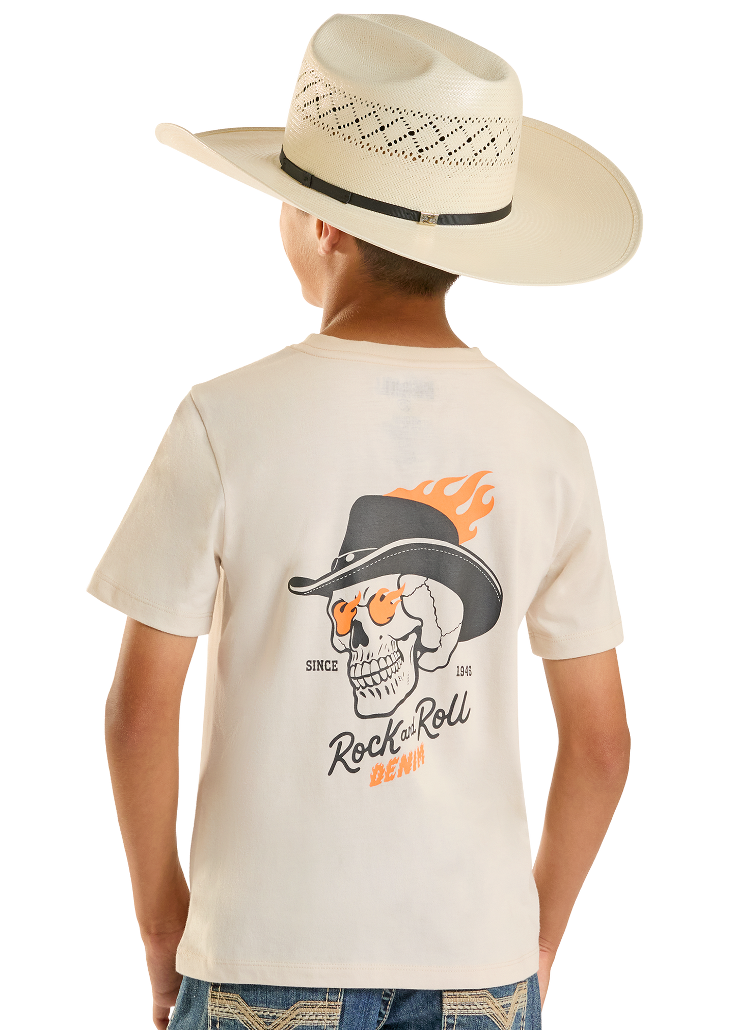 Child wearing a cream t-shirt with a skull graphic and cowboy hat, standing against a white background.