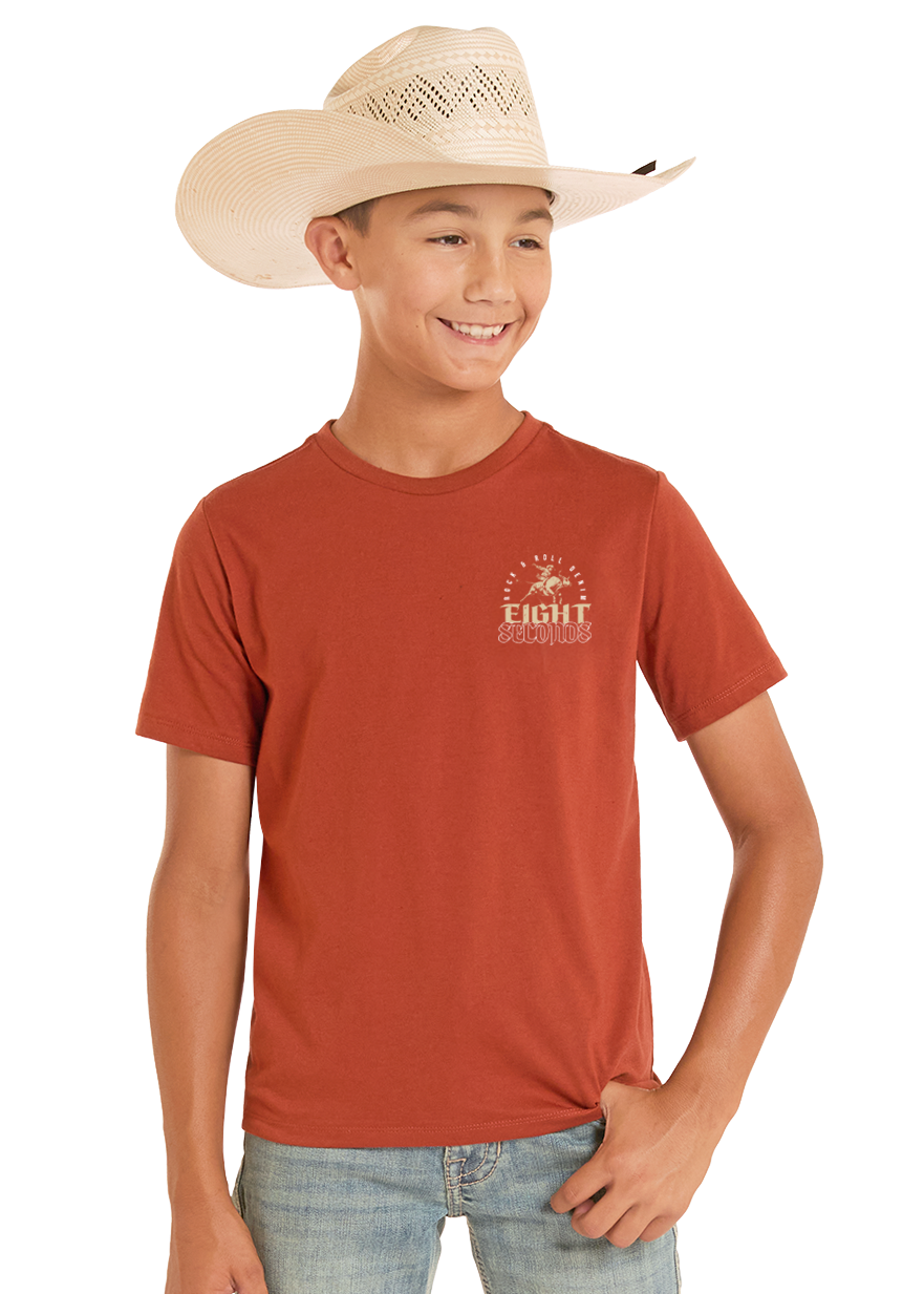 Child wearing a red t-shirt with a logo and light blue jeans on a white background