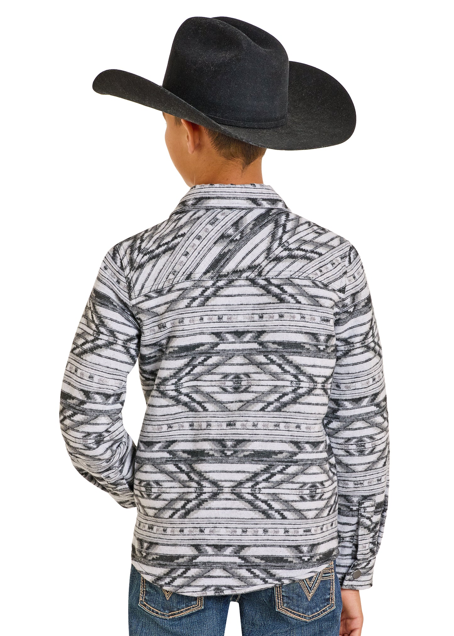 Child wearing a patterned long-sleeve shirt and black cowboy hat on a white background
