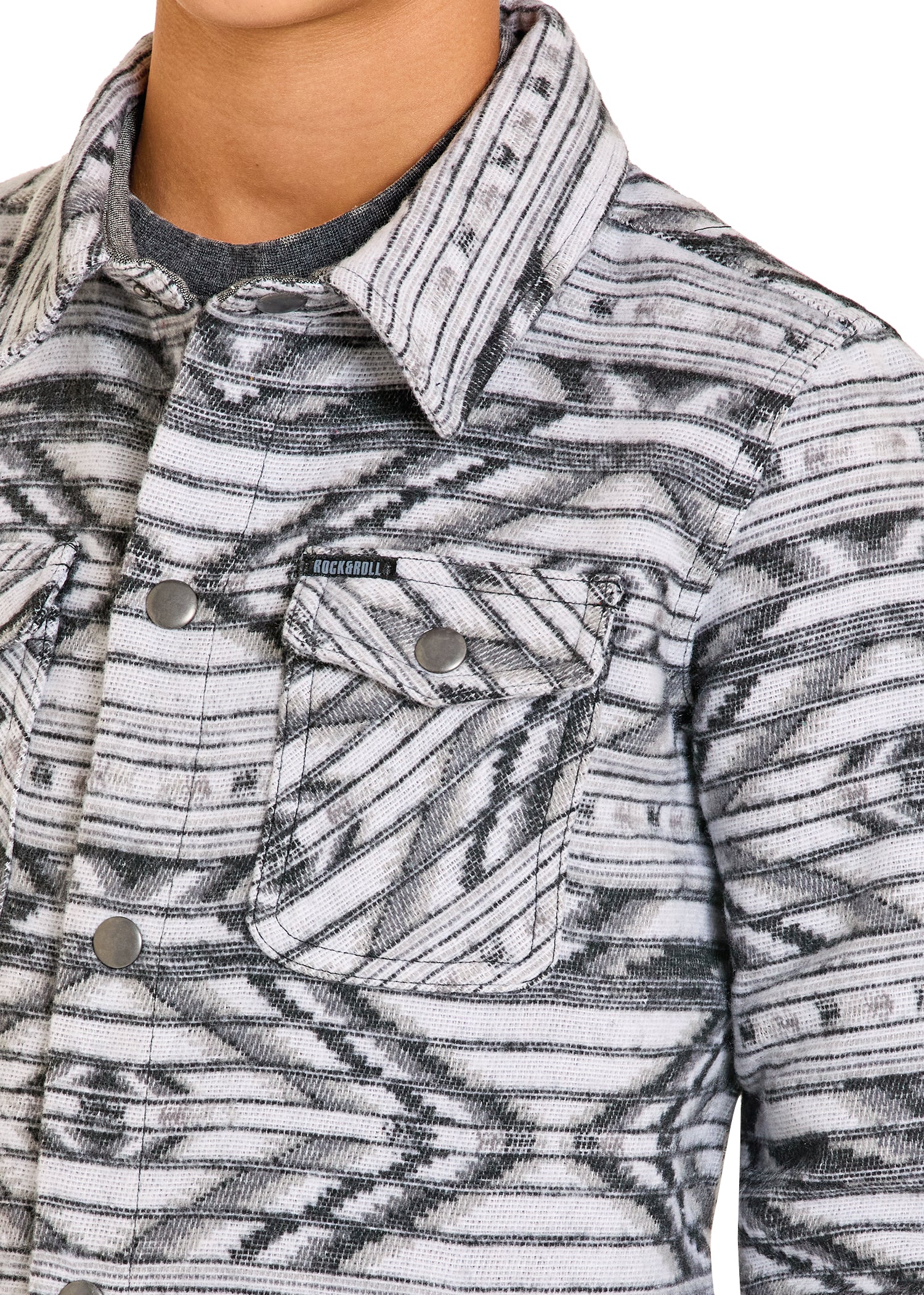 Close-up of a patterned jacket with a brand logo on a white background