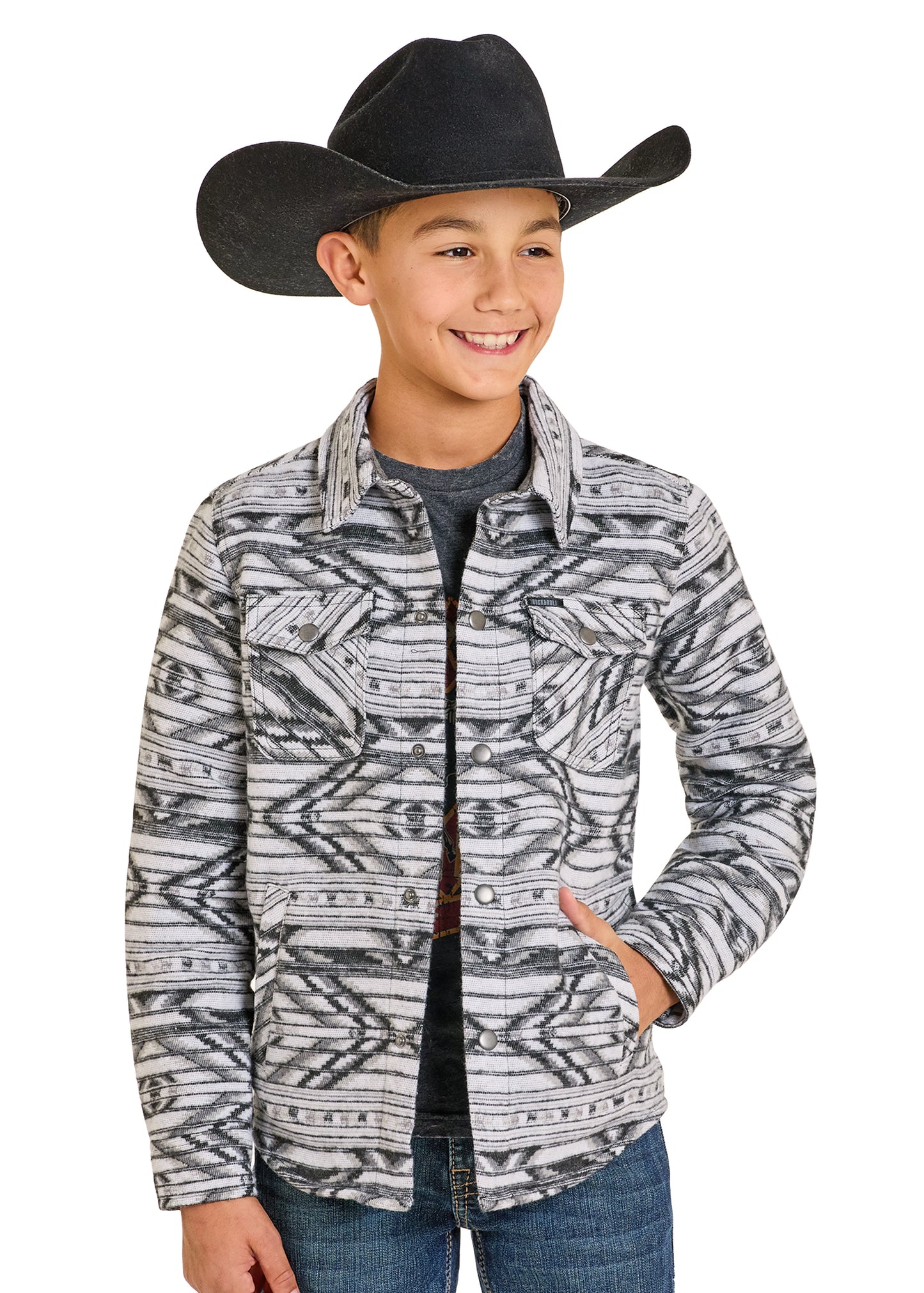 Child wearing a patterned shirt, jeans, and a black cowboy hat on a white background