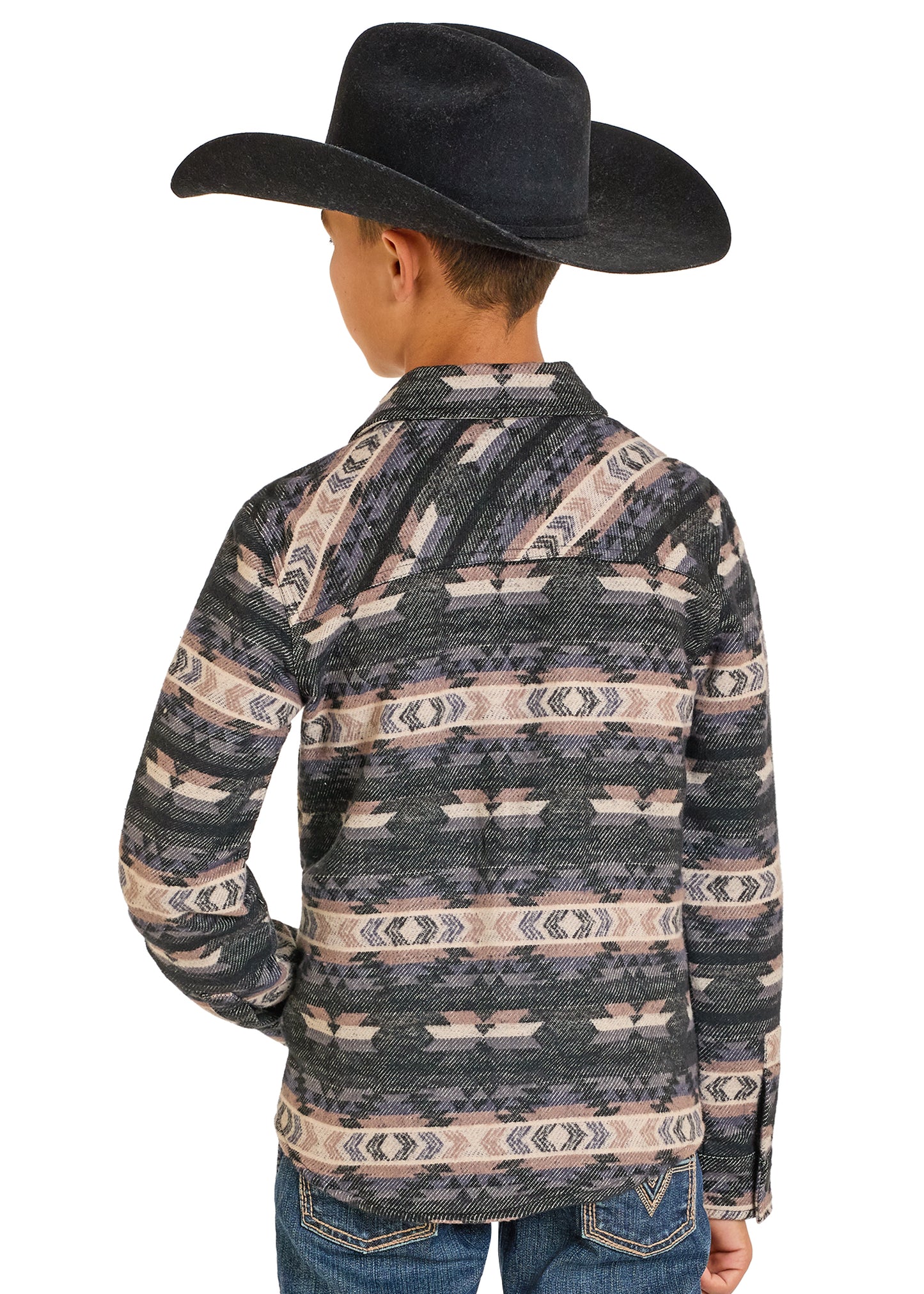 Child wearing a patterned long-sleeve shirt and cowboy hat on a white background