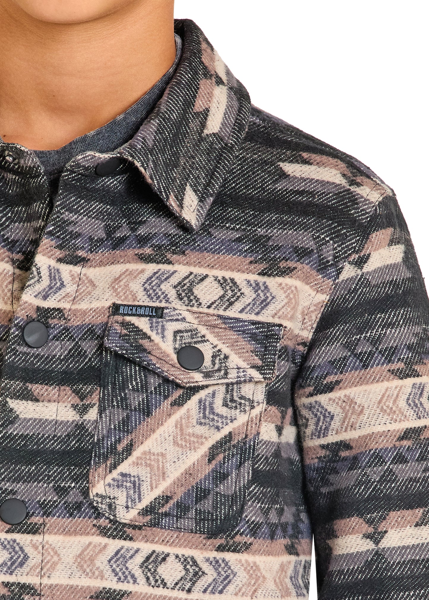 Close-up of a patterned jacket with a brand label on a white background