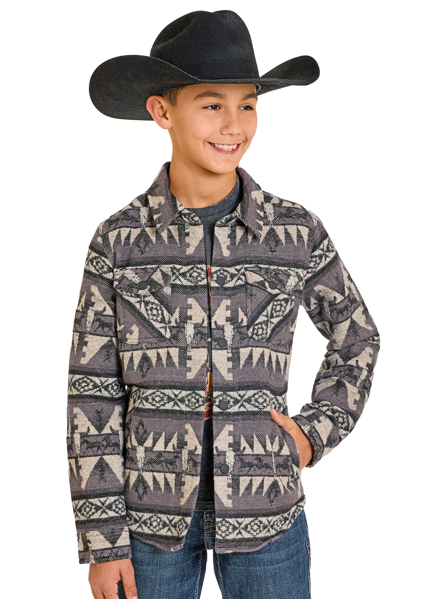 Child wearing a patterned shirt and cowboy hat on a white background